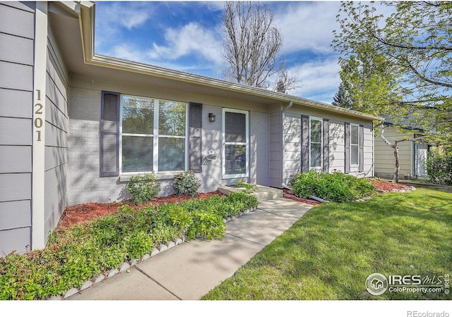 1201 Stein St, Lafayette, CO 80026 - view of exterior entry featuring a lawn