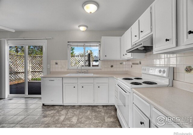 1201 Stein St, Lafayette, CO 80026 - kitchen featuring white appliances, under cabinet range hood, a sink, backsplash, and white cabinetry