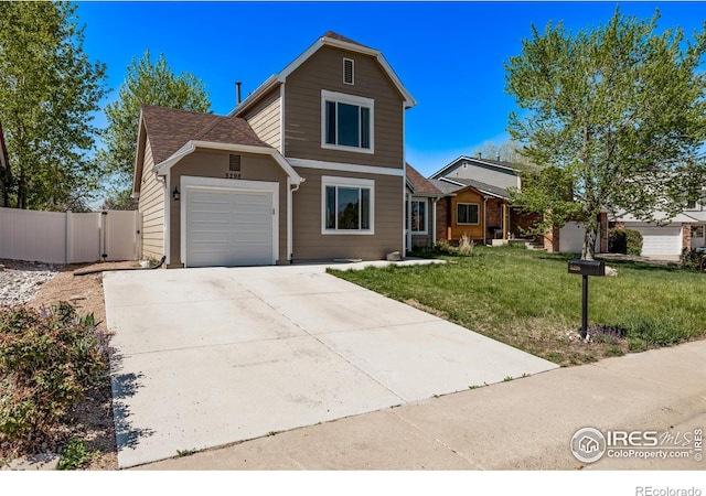 traditional home featuring an attached garage, concrete driveway, and a gate