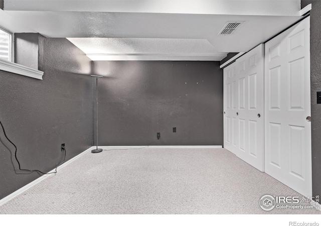 finished below grade area featuring carpet floors and baseboards