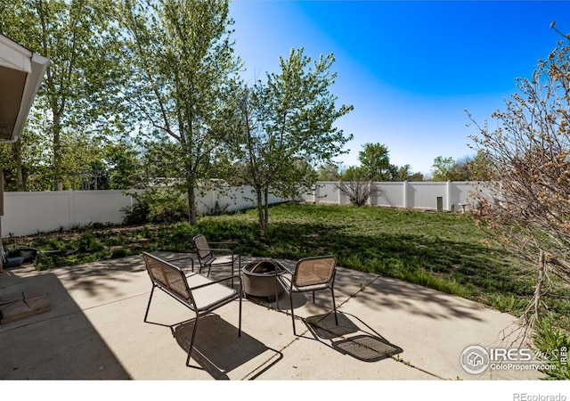 view of patio featuring an outdoor fire pit and a fenced backyard