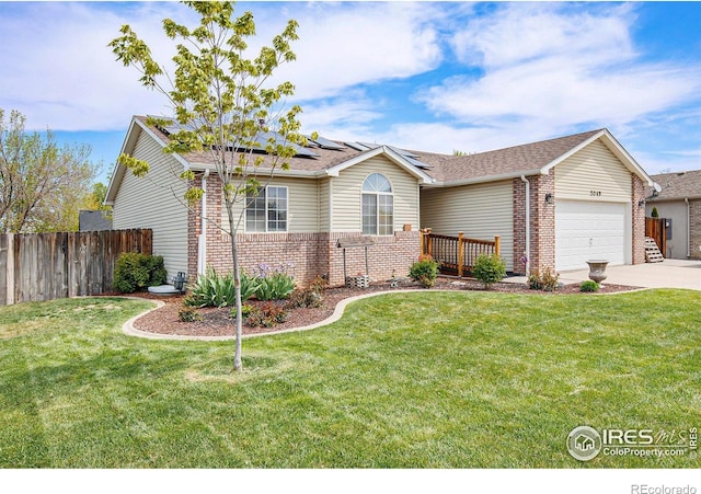 5049 W 2nd Street Rd, Greeley, CO 80634 - single story home featuring an attached garage, brick siding, concrete driveway, and roof mounted solar panels