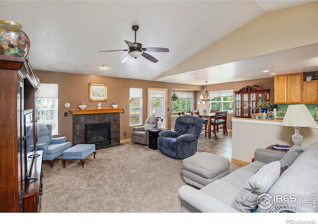 5049 W 2nd Street Rd, Greeley, CO 80634 - living room with vaulted ceiling, ceiling fan, a fireplace, carpet flooring, and baseboards
