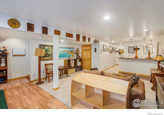 5049 W 2nd Street Rd, Greeley, CO 80634 - living room featuring baseboards, light wood-style floors, recessed lighting, and a textured ceiling
