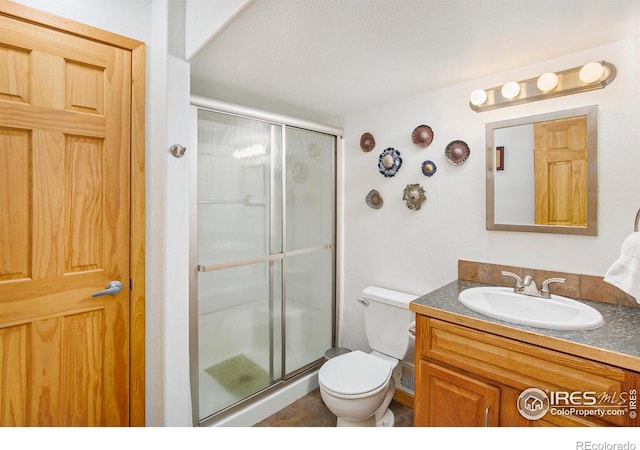 5049 W 2nd Street Rd, Greeley, CO 80634 - full bath featuring a stall shower, toilet, vanity, and tile patterned floors
