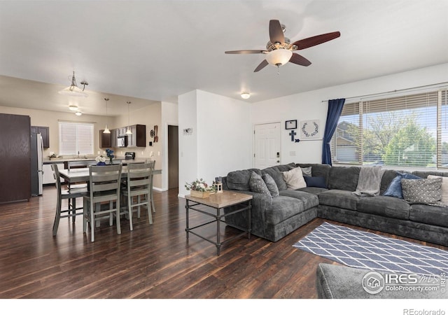 living area with dark wood finished floors and ceiling fan