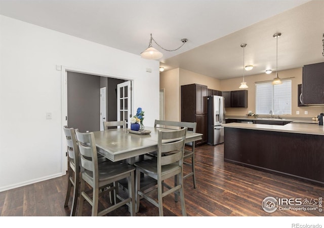 dining room with dark wood finished floors and baseboards
