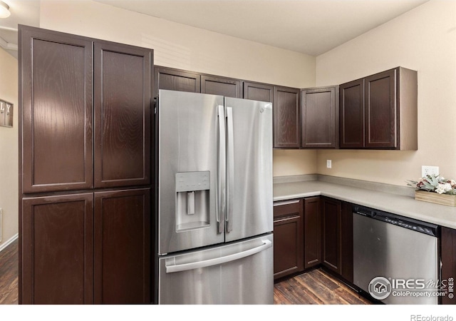 kitchen featuring appliances with stainless steel finishes, dark wood-style flooring, light countertops, and dark brown cabinetry