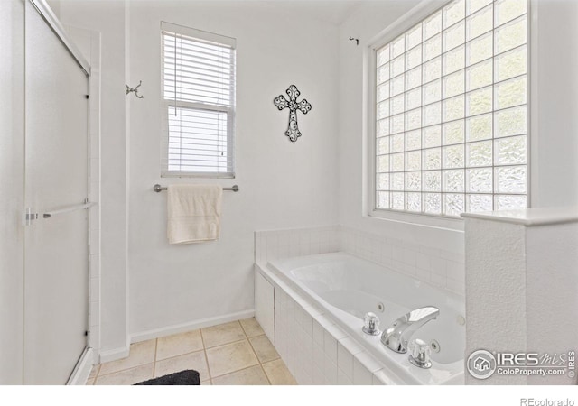 full bath with tile patterned flooring, a stall shower, a tub with jets, and baseboards