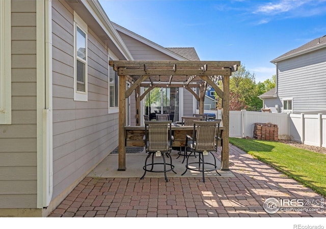 view of patio with a pergola, fence, and outdoor dining space