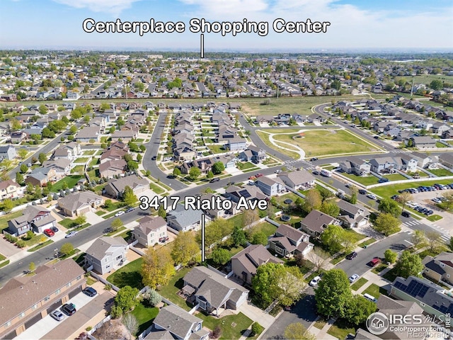 aerial view of property and surrounding area featuring nearby suburban area