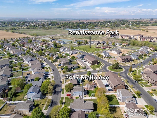 view of property location with nearby suburban area and a large body of water