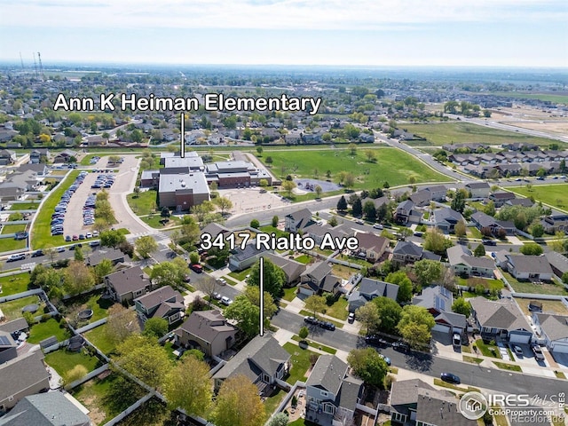 aerial view of property and surrounding area featuring nearby suburban area