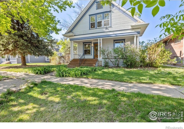 view of front of home with covered porch and a front yard