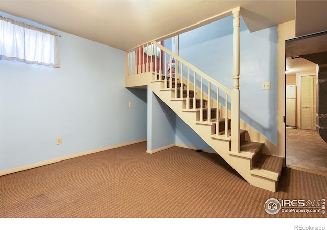 stairway with carpet and baseboards