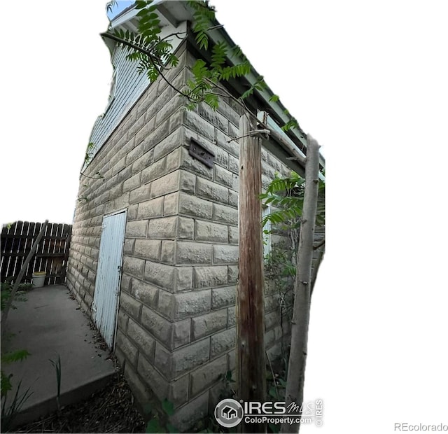 view of side of property featuring fence