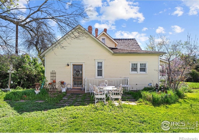 1341 N 95th St, Lafayette, CO 80026 - back of house featuring a chimney and a yard