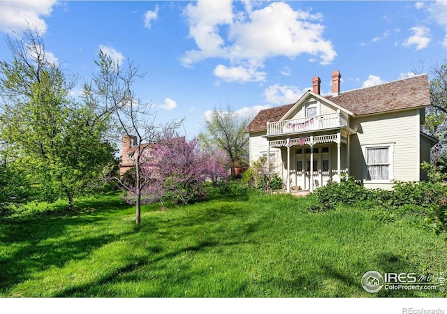 1341 N 95th St, Lafayette, CO 80026 - rear view of property featuring a yard, a chimney, and a wooden deck