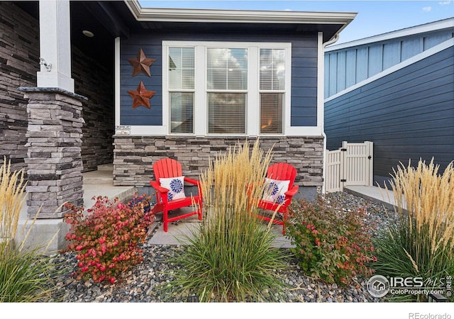 view of home's exterior featuring stone siding and covered porch