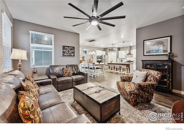 living room featuring wood finished floors and ceiling fan