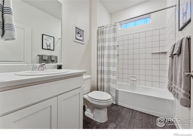 full bathroom featuring toilet, wood finished floors, vanity, and shower / bath combination with curtain