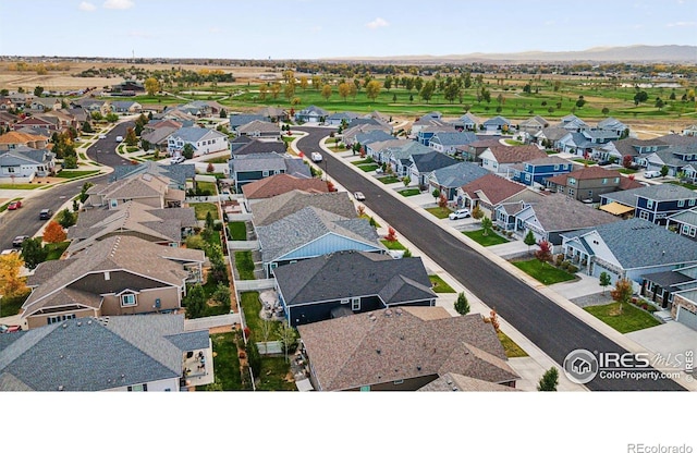 aerial view of residential area featuring mountains
