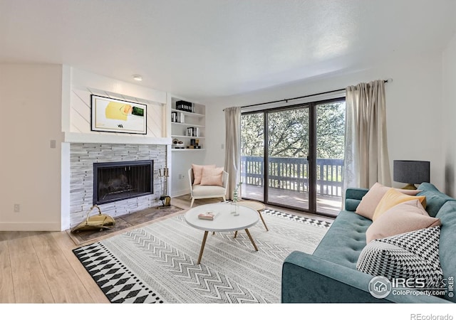 3363 Oneal Pkwy Unit 36, Boulder, CO 80301 - living room with wood finished floors, baseboards, and a stone fireplace