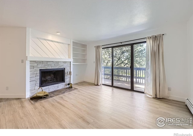 3363 Oneal Pkwy Unit 36, Boulder, CO 80301 - unfurnished living room with wood finished floors, baseboards, a stone fireplace, and built in features