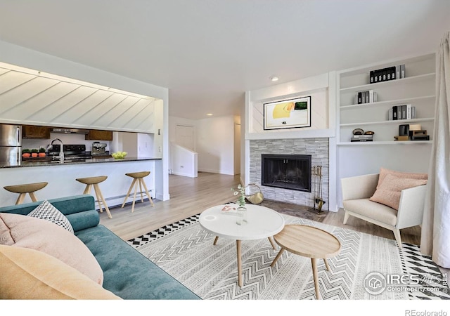 3363 Oneal Pkwy Unit 36, Boulder, CO 80301 - living room featuring wood finished floors, a tile fireplace, baseboard heating, and recessed lighting