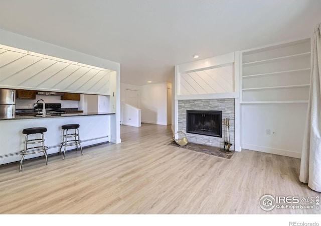 3363 Oneal Pkwy Unit 36, Boulder, CO 80301 - living room featuring light wood-style flooring, baseboard heating, a fireplace, recessed lighting, and baseboards