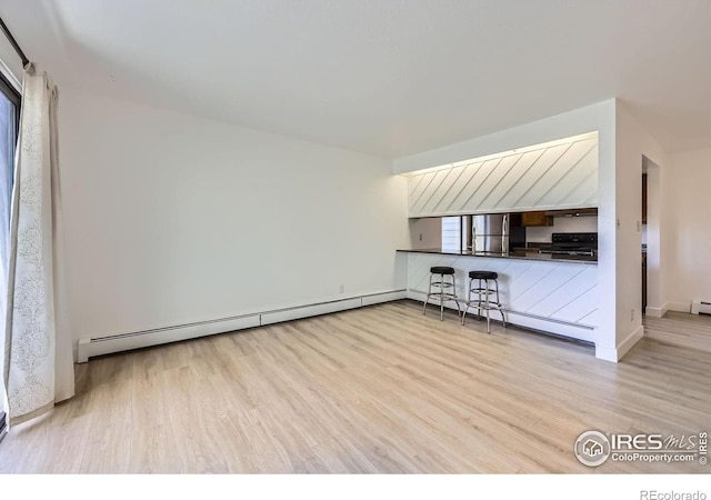 3363 Oneal Pkwy Unit 36, Boulder, CO 80301 - unfurnished living room featuring wood finished floors, baseboard heating, and baseboards
