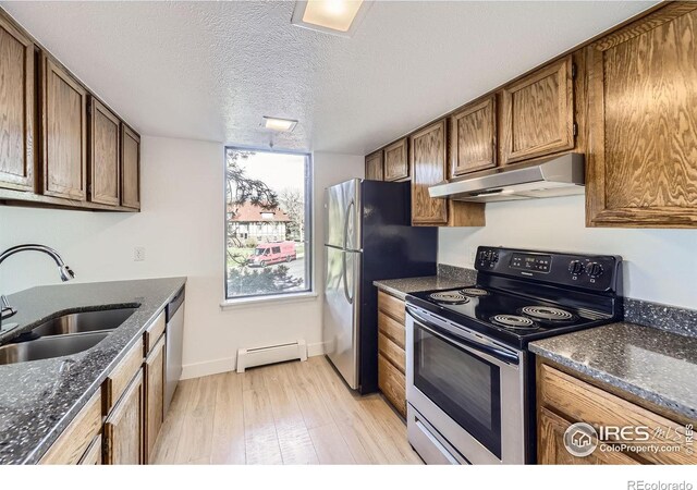 3363 Oneal Pkwy Unit 36, Boulder, CO 80301 - kitchen with under cabinet range hood, stainless steel appliances, baseboard heating, a sink, and light wood-type flooring