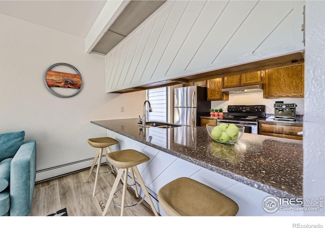 3363 Oneal Pkwy Unit 36, Boulder, CO 80301 - kitchen featuring appliances with stainless steel finishes, a sink, under cabinet range hood, a baseboard radiator, and brown cabinetry