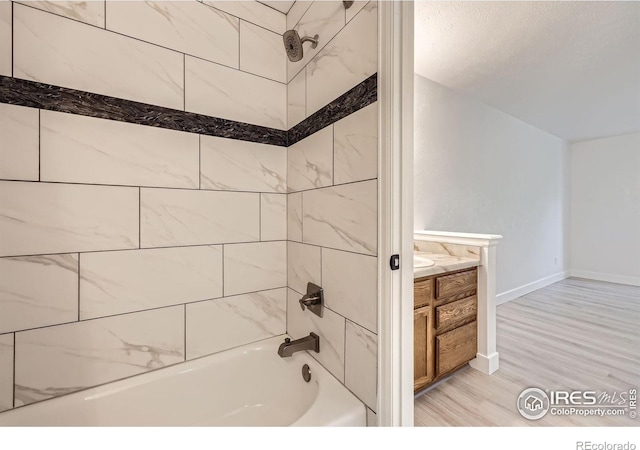 3363 Oneal Pkwy Unit 36, Boulder, CO 80301 - full bathroom featuring  shower combination, wood finished floors, vanity, and baseboards