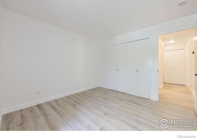 3363 Oneal Pkwy Unit 36, Boulder, CO 80301 - unfurnished bedroom with light wood-type flooring, baseboards, and a closet