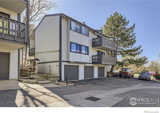 3363 Oneal Pkwy Unit 36, Boulder, CO 80301 - view of property exterior featuring a balcony, an attached garage, and asphalt driveway