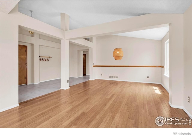 1606 Iris St, Broomfield, CO 80020 - empty room featuring wood finished floors, baseboards, and lofted ceiling