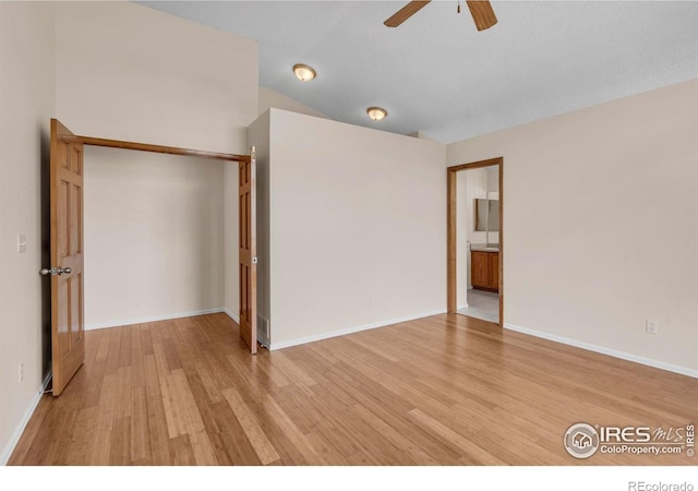 1606 Iris St, Broomfield, CO 80020 - unfurnished bedroom featuring light wood-style flooring, a closet, lofted ceiling, baseboards, and connected bathroom