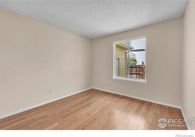 1606 Iris St, Broomfield, CO 80020 - empty room featuring wood finished floors, baseboards, and a textured ceiling
