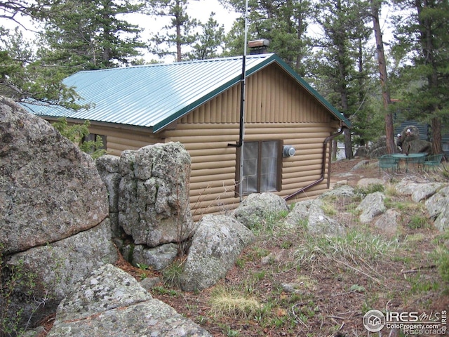 view of property exterior featuring metal roof