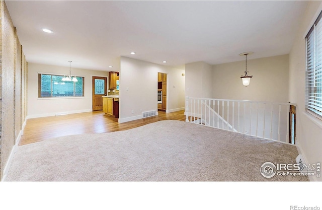 8351 Ralph Ln, Denver, CO 80221 - unfurnished room featuring light carpet, recessed lighting, baseboards, and light wood-style floors