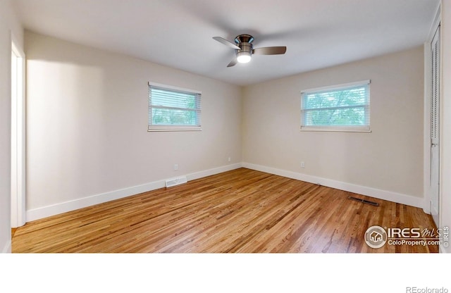 8351 Ralph Ln, Denver, CO 80221 - spare room featuring plenty of natural light, baseboards, and wood finished floors