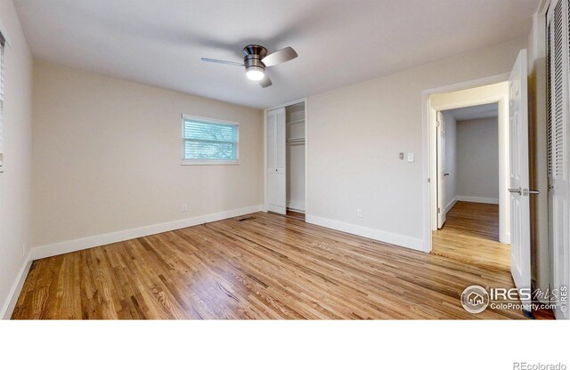 8351 Ralph Ln, Denver, CO 80221 - unfurnished bedroom with wood finished floors, a closet, baseboards, and a ceiling fan