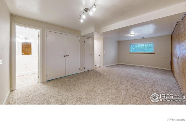 8351 Ralph Ln, Denver, CO 80221 - unfurnished bedroom with carpet flooring, connected bathroom, and baseboards