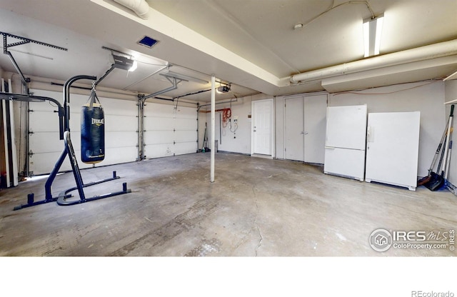 8351 Ralph Ln, Denver, CO 80221 - garage with a garage door opener and freestanding refrigerator
