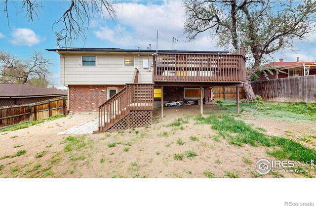 8351 Ralph Ln, Denver, CO 80221 - back of house featuring stairway, a wooden deck, a fenced backyard, and brick siding