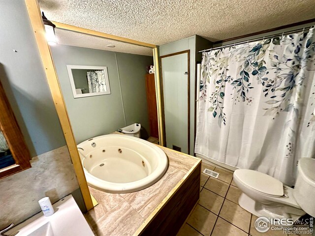 45908 County Road 39, Otis, CO 80743 - bathroom featuring a jetted tub, toilet, a textured ceiling, curtained shower, and tile patterned floors