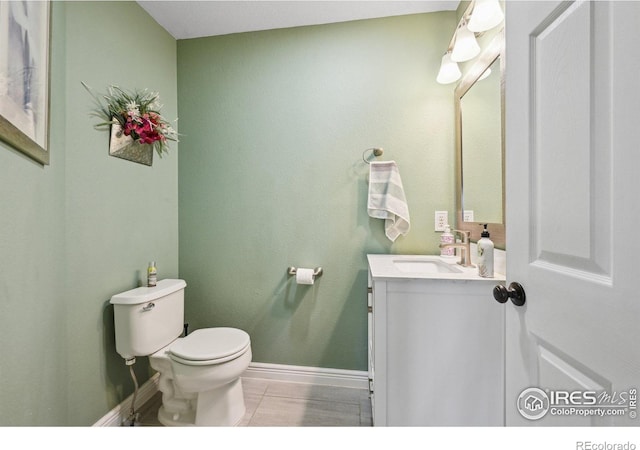 13106 Elizabeth St, Thornton, CO 80241 - bathroom featuring toilet, vanity, baseboards, and tile patterned floors
