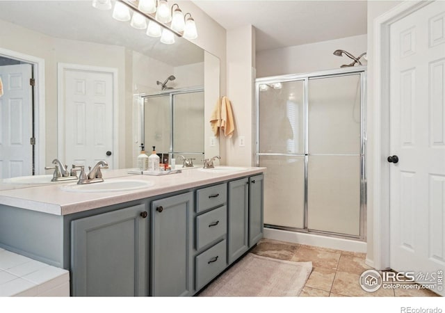 13106 Elizabeth St, Thornton, CO 80241 - bathroom with a stall shower, double vanity, and tile patterned flooring