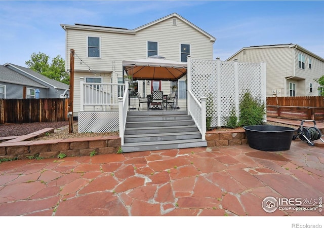 13106 Elizabeth St, Thornton, CO 80241 - back of house featuring a gazebo, fence, a deck, and a patio